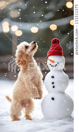 A winter moment when a small dog curious about a snowman plays in the snow 131511375
