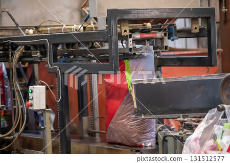 Equipment packaging bulk items in a manufacturing facility during daytime operation Equipment packaging bulk items in a manufacturing facility during daytime operation 131512577