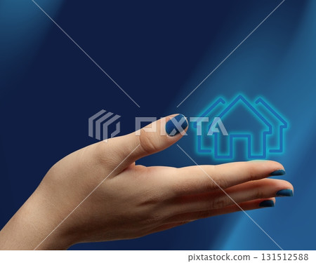 Woman hand holding digital house symbol representing real estate market 131512588