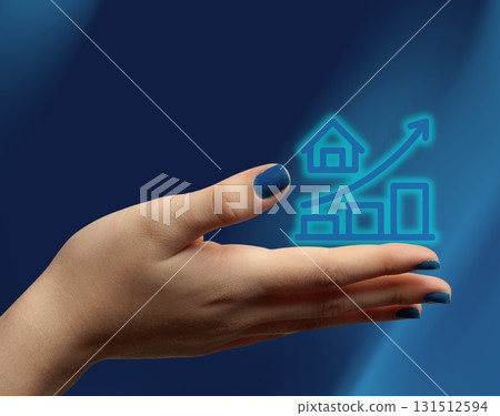 Hand holding upward price icon, concept of increasing housing costs and property investment. 131512594
