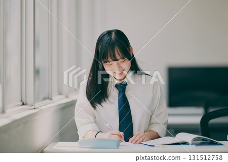 Female junior high school student studying in a cram school classroom Female junior high school student studying in a cram school classroom 131512758
