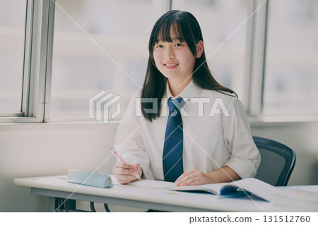 Female junior high school student studying in a cram school classroom Female junior high school student studying in a cram school classroom 131512760