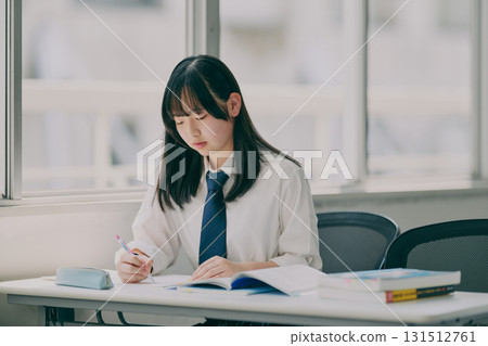 Female junior high school student studying in a cram school classroom Female junior high school student studying in a cram school classroom 131512761