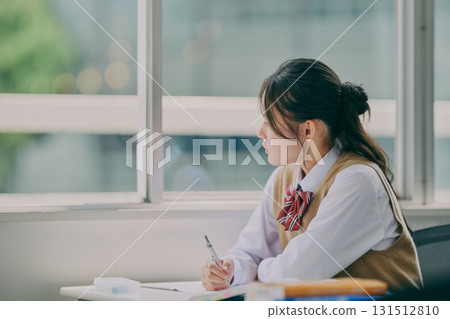 Female junior high school student studying in a cram school classroom Female junior high school student studying in a cram school classroom 131512810