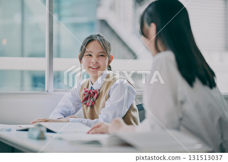 Junior high school students chatting in a cram school classroom 131513037