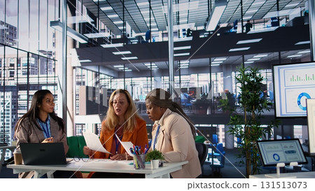 Group of influential businesswomen discussing financial strategies, embodying corporate leadership and resilience to meet project deadlines. Women in a meeting strategizing for expansion. Camera B. Group of influential businesswomen discussing financial strategies, embodying corporate leadership and resilience to meet project deadlines. Women in a meeting strategizing for expansion. Camera B. 131513073