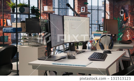 PC screens in innovative startup office showing programming languages used to build applications. Empty software development agency used for optimizing code on computers, handheld camera shot 131513123