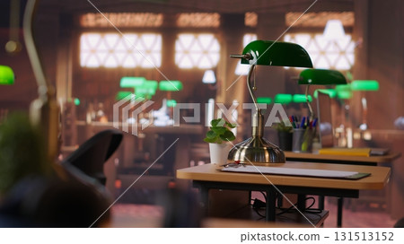 Professional library space designed with historic architecture and study desks, vintage aesthetics offering sophisticated and peaceful environment for research and academic endeavors. Refined space. Professional library space designed with historic architecture and study desks, vintage aesthetics offering sophisticated and peaceful environment for research and academic endeavors. Refined space. 131513152