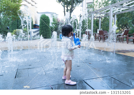 Japanese toddlers playing in the fountain at the apartment complex Japanese toddlers playing in the fountain at the apartment complex 131513201