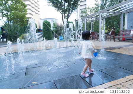 Japanese toddlers playing in the fountain at the apartment complex Japanese toddlers playing in the fountain at the apartment complex 131513202