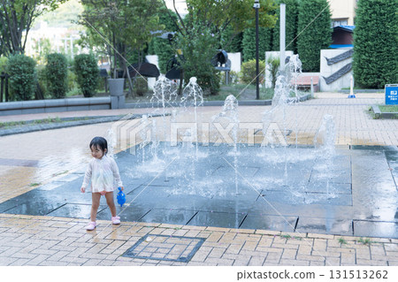 Japanese toddlers playing in the fountain at the apartment complex Japanese toddlers playing in the fountain at the apartment complex 131513262