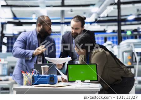 Multiethnic group of technicians work with copy space in a solar energy plant, shares ideas on improving systems and emphasizing strategic planning for technical development. 131513327