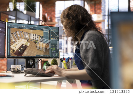 Woman in a modern office creates a 3D render of an apartment interior, utilizing architectural software. Developer uses digital tool to decorate detailed home design, configuring virtual assets. 131513335
