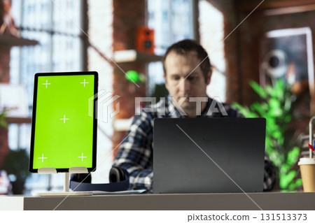 Focus on green screen tablet used by employee in blurry background, editing documents, typing text. Close up of mockup device used by remote worker managing digital paperwork within file directories Focus on green screen tablet used by employee in blurry background, editing documents, typing text. Close up of mockup device used by remote worker managing digital paperwork within file directories 131513373
