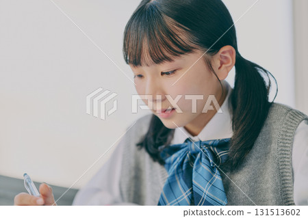 Female junior high school student studying in a cram school classroom 131513602
