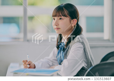 Female junior high school student studying in a cram school classroom Female junior high school student studying in a cram school classroom 131513607