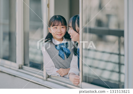 Junior high school girls talking by the window 131513821