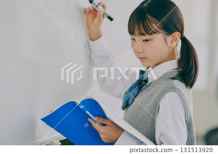 Female junior high school student studying in a cram school classroom Female junior high school student studying in a cram school classroom 131513920