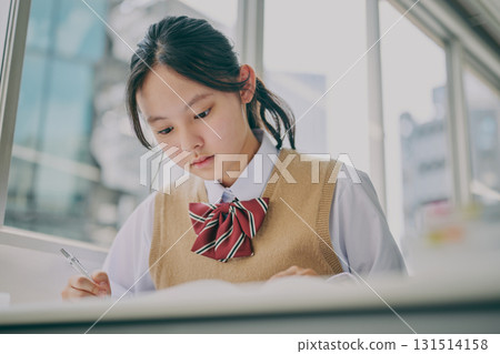 Female junior high school student studying in a cram school classroom 131514158