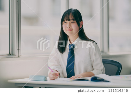 Female junior high school student studying in a cram school classroom 131514246