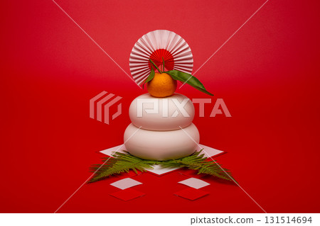 A photo of a Kagami mochi (rice cake) placed in the center, red background, no sanpo (base) A photo of a Kagami mochi (rice cake) placed in the center, red background, no sanpo (base) 131514694