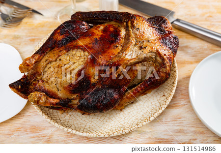 Browned baked duck stuffed with barley and mushrooms 131514986
