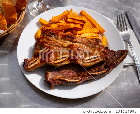 Churrasco de ternera, grilled veal spare ribs with fries 131514995