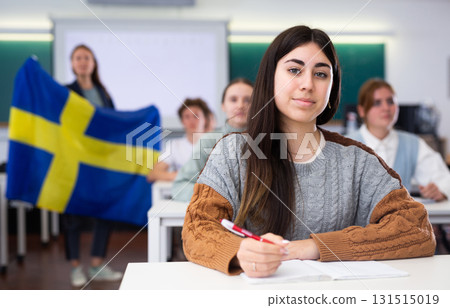 Young girl student diligently studies at school 131515019