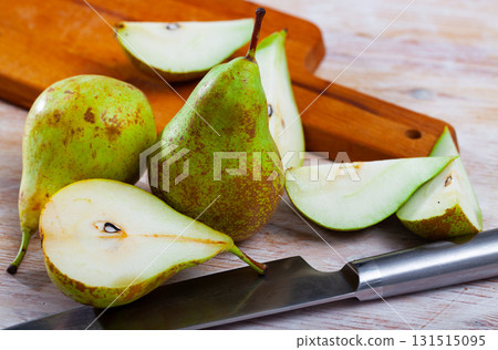Ripe pears and knife on wooden cutting board Ripe pears and knife on wooden cutting board 131515095
