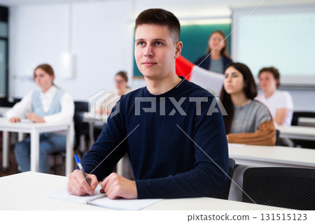 Young boy student studying diligently at school Young boy student studying diligently at school 131515123