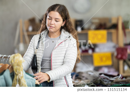 During November sales, young woman choose and buy something autumn outwear 131515134