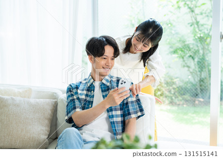 夫婦在客廳裡看智能手機 131515141