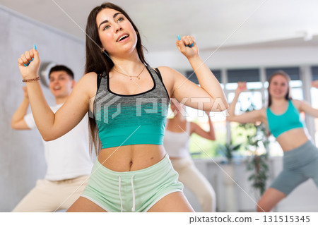 Expressive teen girl krumper dancing with group of teenagers in studio 131515345