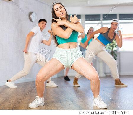 Group of young women and young guy dancing hip hop Group of young women and young guy dancing hip hop 131515364