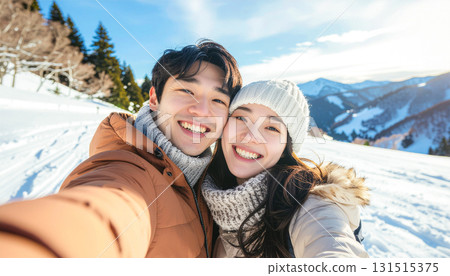 Couple taking a selfie on a snowy mountain 131515375