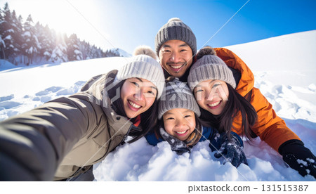 Family taking a selfie on a snowy mountain Family taking a selfie on a snowy mountain 131515387