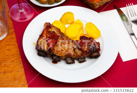 Portion of honey glazed beef ribs with potato 131515622