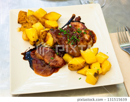 Baked sirloin medallion with potato at white plate Baked sirloin medallion with potato at white plate 131515639