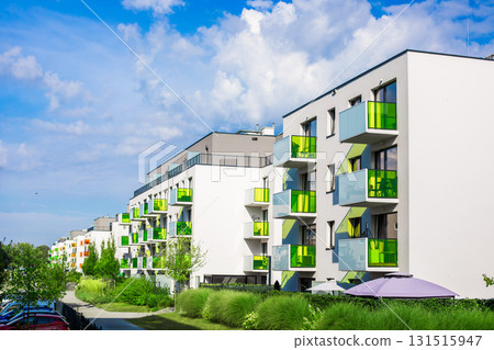 Modern residential apartment buildings with colorful green balconies and contemporary architecture  131515947