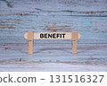 Benefit symbol. Single Wooden stick squeezed by Clothespins, Grungy blue Wooden Texture Background. Business and Benefit concept with copy space 131516327