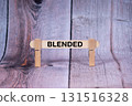 Blended symbol. Single Wooden stick supported by Clothespins, beautiful Light Orange tone highlight Wooden Texture Background. Business and Blended concept with copy space 131516328