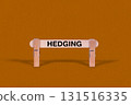 Hedging symbol. Wooden stick tightened by Clothespins, beautiful Orange color Backdrop. Business and Hedging concept with copy space 131516335