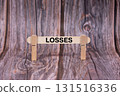 Losses symbol. A wooden stick clasped by clothespins set over a beautiful Brown Grunge Wooden Texture Background. Business and Losses concept with copy space 131516336