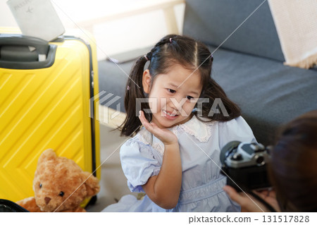 Playful Moment. Young girl posing for a photo while preparing for travel. Playful Moment. Young girl posing for a photo while preparing for travel. 131517828
