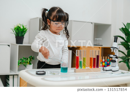 toddler girl scientist making chemical test with test tube and beaker. learning science toddler girl scientist making chemical test with test tube and beaker. learning science 131517854