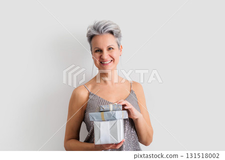 Smiling happy lady 50 years old with gray hair and short haircut looking at camera 131518002
