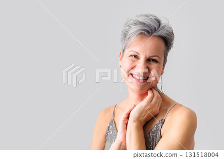 Beautiful happy middle-aged elderly woman with gray short hair smiling and looking at camera. Beautiful happy middle-aged elderly woman with gray short hair smiling and looking at camera. 131518004