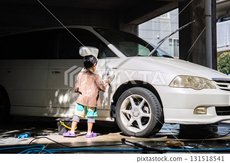 5-year-old boy helping with car wash 131518541