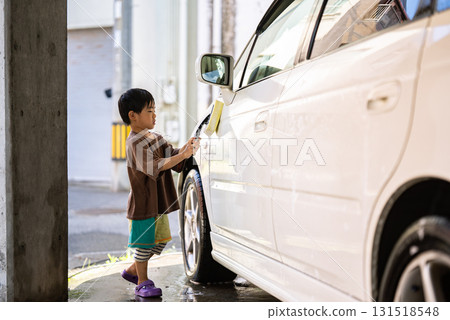 5-year-old boy helping with car wash 131518548
