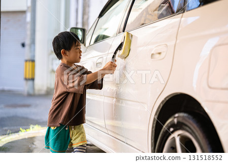 5-year-old boy helping with car wash 5-year-old boy helping with car wash 131518552